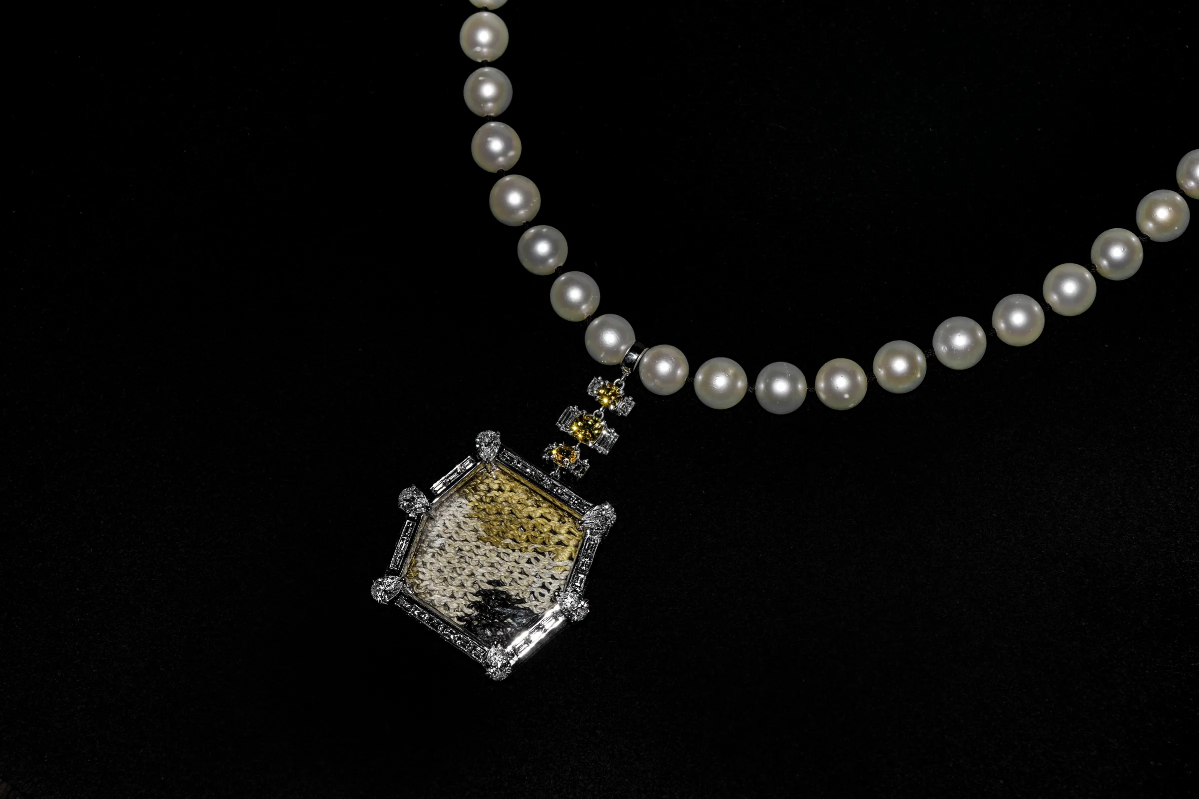 Necklace I with pearl strand and woven textile pendant
